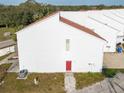 Rear view of townhome with red door at 9406 Citrus Glen Pl, Tampa, FL 33618