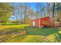 Red metal outbuilding with tires and other items at 11201 Knotty Pine Dr, New Port Richey, FL 34654