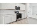 Stainless steel appliances and white cabinets at 12213 Tranquil Waters Ter, Parrish, FL 34219
