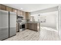 Modern kitchen with stainless steel appliances and light wood cabinets at 14198 89Th Ave, Seminole, FL 33776