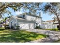 Two-story house with double garage and landscaped lawn at 1600 Gray Bark Dr, Oldsmar, FL 34677