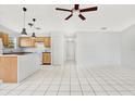 Open living room and kitchen area with tile floors and ceiling fan at 1637 82Nd Street E Ct, Palmetto, FL 34221