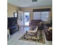 Living room features a cozy seating area and view to front yard at 1736 Thomas Dr, Clearwater, FL 33759