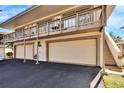 Side view of a two-story condo, double garage, and stairs at 1849 Bough Ave # D, Clearwater, FL 33760