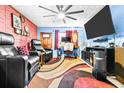 Relaxing living room with leather recliners and a large TV at 1907 27Th W St, Bradenton, FL 34205
