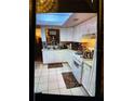 Kitchen with white cabinets, white appliances, and tiled floor at 2504 Highland S St, St Petersburg, FL 33705