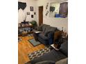 Living room with dark-colored couch and wood flooring at 2504 Highland S St, St Petersburg, FL 33705