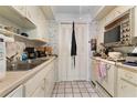 Small condo kitchen with white cabinets and appliances at 2630 Pearce Dr # 102, Clearwater, FL 33764