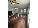 Spacious living room featuring hardwood floors and a modern TV stand at 2811 Butterfly Landing Dr, Land O Lakes, FL 34638