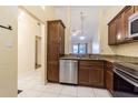 Kitchen with stainless steel appliances and wood cabinets at 327 Petrea Dr # 327, Palm Harbor, FL 34684