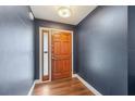 Bright entryway with hardwood floors and a wooden door at 4113 Barret Ave, Plant City, FL 33566