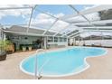 Relaxing kidney-shaped pool with screened enclosure at 4113 Barret Ave, Plant City, FL 33566