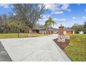 House exterior featuring a long driveway and landscaping at 4825 Scott Rd, Lutz, FL 33558