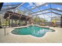 Inviting pool area with a covered patio and outdoor kitchen at 4825 Scott Rd, Lutz, FL 33558