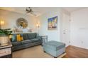 Living room features gray couch, ottoman, and coastal decor at 5005 Coquina Key Se Dr # E, St Petersburg, FL 33705