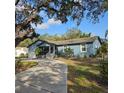 Cute ranch home with a long driveway and tropical landscaping at 604 8Th Sw St, Ruskin, FL 33570