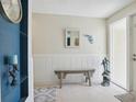 Bright and airy entryway with a built-in bench and coastal decor at 7698 Cardiff Ct, St Petersburg, FL 33709