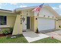 House exterior showcasing a white front door and attached garage at 7698 Cardiff Ct, St Petersburg, FL 33709