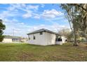 Rear view of the home with a patio and open space at 902 W Alsobrook St, Plant City, FL 33563
