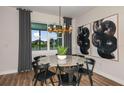 Bright dining room with round table and modern art at 9413 Barnacle Ln, Parrish, FL 34219
