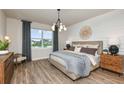Spacious main bedroom with wood-like floors and large window at 9413 Barnacle Ln, Parrish, FL 34219