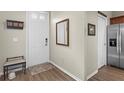 Bright entryway with wood-look floors and a bench at 11522 Fountainhead Dr, Tampa, FL 33626