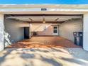 Attached garage with tiled floor, open door, and space for storage at 11824 Cypress Crest Cir, Tampa, FL 33626