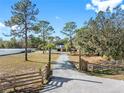 Long gravel driveway leading to a two-story house at 14450 Lancer Rd, Spring Hill, FL 34610