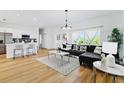 Spacious living room with L-shaped sectional sofa and wood floors at 14469 Bulger Ave, Port Charlotte, FL 33953