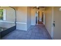 Screened-in porch with tiled floor, leading to the home's entrance at 1526 Leland Dr # 1525, Sun City Center, FL 33573