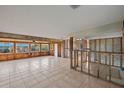 Large living room undergoing renovation with tiled floors and new windows at 159 Danforth Dr, Punta Gorda, FL 33980