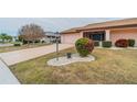 Landscaped yard with a paved driveway at 1607 Dower Way, Sun City Center, FL 33573