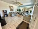 Living room with sofas, coffee table, and tiled floors at 169 Medallion Blvd # E, Madeira Beach, FL 33708