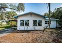 Newly painted house with blue accents at 1820 Sutherland W Dr, Palm Harbor, FL 34683