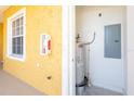 Exterior utility closet with water heater and electrical panel at 21012 Picasso Ct # J205, Land O Lakes, FL 34637