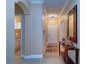Bright entryway with tile floors and a console table at 2749 Via Cipriani # 1010B, Clearwater, FL 33764