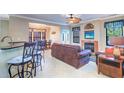 Spacious living room with fireplace and leather sofas at 2749 Via Cipriani # 1010B, Clearwater, FL 33764