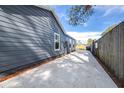 Side view of gray house exterior with concrete driveway and fence at 2859 38Th N Ave, St Petersburg, FL 33713