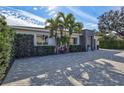 Modern home exterior, paver driveway & lush landscaping at 3312 W Swann Ave, Tampa, FL 33609