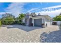 Contemporary home with paver driveway & tropical landscaping at 3312 W Swann Ave, Tampa, FL 33609