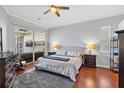 Main bedroom with wood floors, sliding doors to lanai, and ensuite bath at 4531 Swordfish Dr, Bradenton, FL 34208