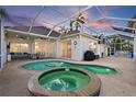 Inviting pool and spa area with covered patio and outdoor lighting at 4531 Swordfish Dr, Bradenton, FL 34208