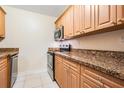 Efficient kitchen featuring granite countertops and wood cabinets at 5221 Bayshore Blvd # 37, Tampa, FL 33611