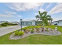 House exterior with well-maintained landscaping and a three-car garage at 676 Allegheny Dr, Sun City Center, FL 33573