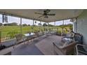 Relaxing screened porch overlooking the golf course with wicker furniture at 676 Allegheny Dr, Sun City Center, FL 33573