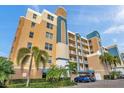 Exterior view of a condo building with palm trees and parking at 960 Starkey Rd # 5301, Largo, FL 33771