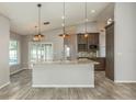 Modern kitchen with granite countertops, stainless steel appliances, and an island at 1028 Wyndham Way, Safety Harbor, FL 34695