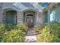 Elegant double front doors with stone columns and landscaping at 12113 Marblehead Dr, Tampa, FL 33626
