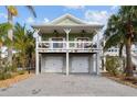 Two-story house with double garage and attractive curb appeal at 12116 Lagoon Ln, Treasure Island, FL 33706
