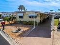Single-wide manufactured home with carport and landscaped yard at 170 S Saint Thomas Cir, Apollo Beach, FL 33572
